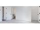 A spacious bedroom with neutral carpeting, white walls, and an open closet at 6236 Kenbrook Dr, Tucker, GA 30084