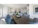 Open-concept dining room and kitchen with white cabinets and modern dining table at 6236 Kenbrook Dr, Tucker, GA 30084