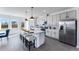 Modern kitchen featuring a spacious island with seating, stainless steel appliances, and stylish pendant lighting at 6236 Kenbrook Dr, Tucker, GA 30084