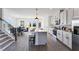 Open-concept kitchen and dining area with white cabinets, stainless appliances, and a large center island at 6236 Kenbrook Dr, Tucker, GA 30084