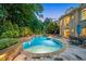 Beautiful backyard featuring a luxurious pool and spa, and ample lounge space surrounded by greenery at 8109 Lawnview, Alpharetta, GA 30022