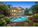 Beautiful backyard featuring a luxurious pool and spa, and ample lounge space surrounded by greenery at 8109 Lawnview, Alpharetta, GA 30022