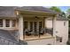 Balcony with stone floor, furniture, iron railing, and view of the yard at 8109 Lawnview, Alpharetta, GA 30022