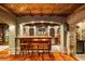 Home bar area with copper ceiling, wooden bar, brick accents, and seating creates a rustic and inviting entertainment space at 8109 Lawnview, Alpharetta, GA 30022
