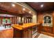 Custom bar with wood cabinets, brick accents, stone archway, and seating area in background at 8109 Lawnview, Alpharetta, GA 30022