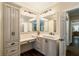 Bathroom featuring cabinetry with marble countertop, dual mirrors, and wood look tile flooring at 8109 Lawnview, Alpharetta, GA 30022
