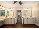 Bright bathroom featuring dual vanities, wood floors, framed mirrors, and updated fixtures at 8109 Lawnview, Alpharetta, GA 30022
