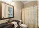 Traditional bathroom features a dark vanity with a bronze faucet, a standard toilet and tile flooring at 8109 Lawnview, Alpharetta, GA 30022