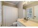 Neutral bathroom featuring a cream colored vanity, a standard toilet and a tiled floor at 8109 Lawnview, Alpharetta, GA 30022