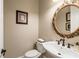 Elegant powder room featuring an ornate mirror and stylish fixtures at 8109 Lawnview, Alpharetta, GA 30022