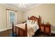 A traditionally styled bedroom featuring a wood-framed bed, matching nightstands, and hardwood floors for a cozy retreat at 8109 Lawnview, Alpharetta, GA 30022