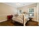 Comfortable bedroom with a metal frame bed, two windows and dark hardwood flooring at 8109 Lawnview, Alpharetta, GA 30022