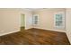 Bedroom with hardwood floors and two windows with wood shutters at 8109 Lawnview, Alpharetta, GA 30022