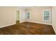 Bedroom featuring hardwood floors, two windows, and neutral colored walls at 8109 Lawnview, Alpharetta, GA 30022