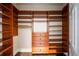 Custom walk-in closet with built-in wood shelving and drawers at 8109 Lawnview, Alpharetta, GA 30022