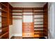 Custom walk-in closet offers ample storage with shelving, drawers, and hanging space for any wardrobe at 8109 Lawnview, Alpharetta, GA 30022
