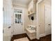 Charming entryway with a built-in bench, storage cabinets, coat hooks, and dark wood flooring at 8109 Lawnview, Alpharetta, GA 30022