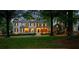 Traditional style home with green lawn, mature trees, and black shutters and a covered porch at 8109 Lawnview, Alpharetta, GA 30022