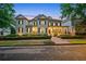Elegant home with a brick walkway, inviting front porch, and meticulously maintained landscaping at 8109 Lawnview, Alpharetta, GA 30022