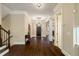 Grand foyer showcasing dark hardwood floors, an elegant chandelier, and views to adjacent rooms at 8109 Lawnview, Alpharetta, GA 30022