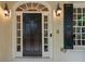 Elegant front door with sidelights and decorative lighting, complementing the home's classic facade at 8109 Lawnview, Alpharetta, GA 30022