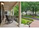 Charming front porch with rocking chairs, white columns, and professional landscaping at 8109 Lawnview, Alpharetta, GA 30022