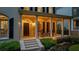 Charming front porch with rocking chairs and an arched entryway, creating a warm and inviting welcome at 8109 Lawnview, Alpharetta, GA 30022