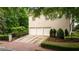 Spacious three-car garage with mature trees and landscaping at 8109 Lawnview, Alpharetta, GA 30022