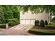Spacious three-car garage with a private driveway and manicured landscaping at 8109 Lawnview, Alpharetta, GA 30022