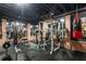 Well-equipped home gym with brick walls, exercise machines, free weights, and rubber flooring, promoting a healthy lifestyle at 8109 Lawnview, Alpharetta, GA 30022