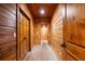 Wood-paneled hallway with brick floors and multiple doorways at 8109 Lawnview, Alpharetta, GA 30022
