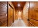 Long hallway with wooden ceilings and walls and brick flooring to give the home a rustic feel at 8109 Lawnview, Alpharetta, GA 30022
