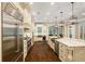 Large gourmet kitchen with an oversized refrigerator, a cooktop, and an oversized island at 8109 Lawnview, Alpharetta, GA 30022