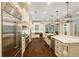 Well-appointed kitchen with stainless steel appliances, a large island, and a view to the living area at 8109 Lawnview, Alpharetta, GA 30022