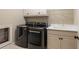 Laundry room with washer, dryer, cabinets, utility sink, and tiled flooring at 8109 Lawnview, Alpharetta, GA 30022
