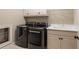 Laundry room with front loading washer and dryer, white cabinets and laundry sink at 8109 Lawnview, Alpharetta, GA 30022