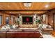 Inviting living room featuring wood-paneled ceiling, stone accents, and plush leather seating, perfect for relaxation and entertainment at 8109 Lawnview, Alpharetta, GA 30022
