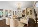 Spacious living room features fireplace, hardwood floors, large windows and staircase access at 8109 Lawnview, Alpharetta, GA 30022
