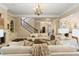 Open-concept living room with elegant staircase and views into the kitchen and entry at 8109 Lawnview, Alpharetta, GA 30022