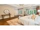 Sun-filled main bedroom features hardwood floors, a ceiling fan, and a seating area with doors to the outside at 8109 Lawnview, Alpharetta, GA 30022