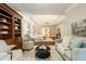 This main bedroom features tray ceilings, an en suite bathroom, a sitting area, and neutral decor at 8109 Lawnview, Alpharetta, GA 30022
