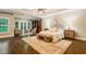 Spacious bedroom with hardwood floors, tray ceilings, and a sitting area with French doors to the backyard at 8109 Lawnview, Alpharetta, GA 30022