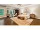 Spacious main bedroom with a sitting area, built-in bookcase, ceiling fan, and hardwood floors at 8109 Lawnview, Alpharetta, GA 30022