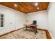 Bright home office with hardwood floors, a wooden ceiling, and an area rug providing a functional and stylish workspace at 8109 Lawnview, Alpharetta, GA 30022