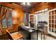 Sophisticated home office with wood paneling, custom built-ins, and ample natural light at 8109 Lawnview, Alpharetta, GA 30022
