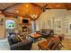 Covered outdoor living space featuring a stone fireplace, grill and comfortable seating area at 8109 Lawnview, Alpharetta, GA 30022