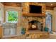Outdoor kitchen space featuring a stone fireplace and grill at 8109 Lawnview, Alpharetta, GA 30022