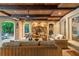 Covered patio with brick fireplace, wood ceiling, ceiling fan, and wicker furniture seating area at 8109 Lawnview, Alpharetta, GA 30022