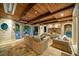 Covered patio with brick accents, wood ceiling, ceiling fan, stone flooring, and wicker seating area at 8109 Lawnview, Alpharetta, GA 30022