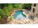 Backyard boasts a luxurious in-ground pool, hot tub, stone patio, and lush landscaping at 8109 Lawnview, Alpharetta, GA 30022